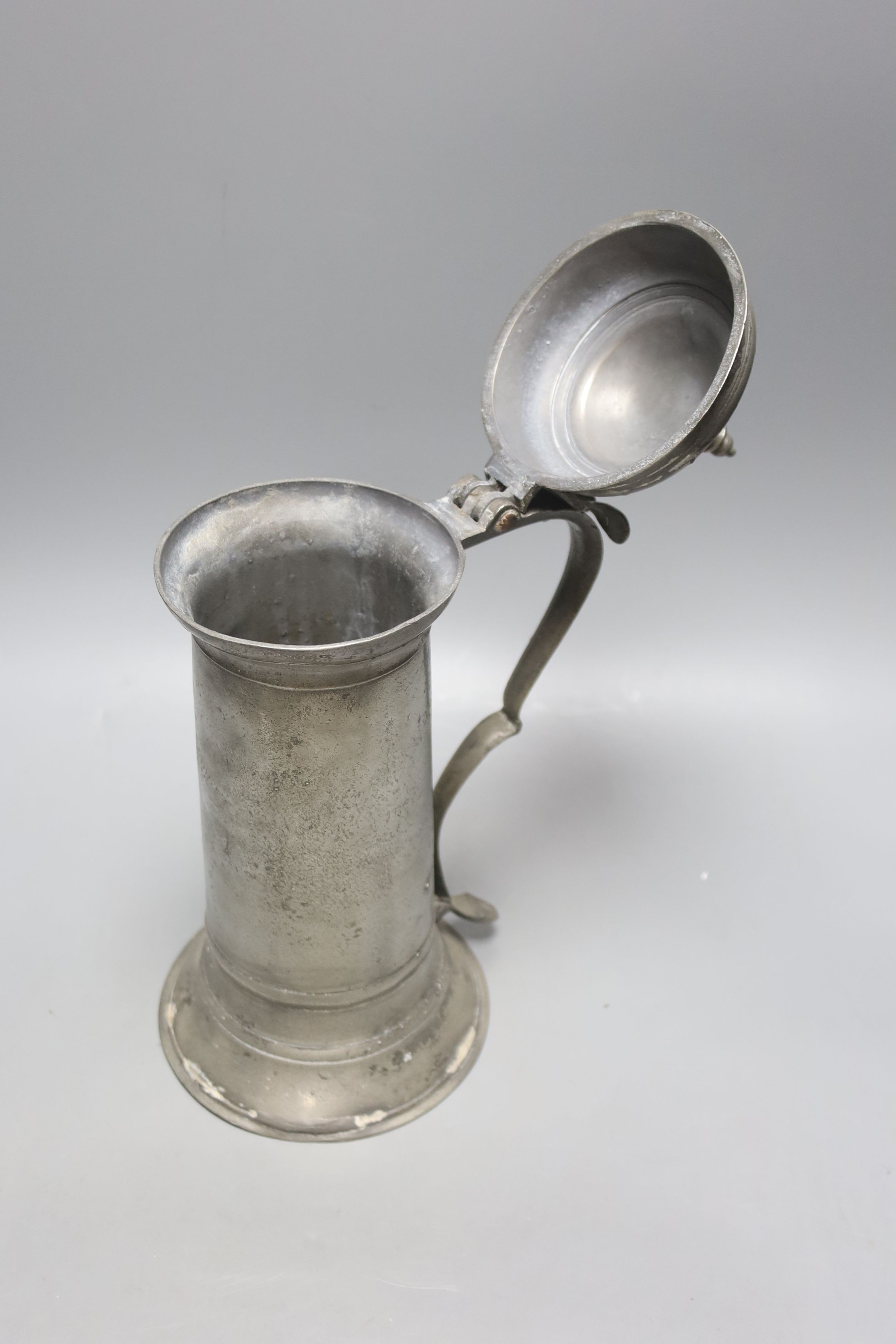 A Charles II pewter flagon, c.1675, with domed lid and turned finial and bifurcated thumbpiece, 33cm